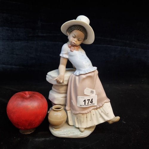 174 - A large Lladró porcelain figure of a young girl with a water jug by her feet from the Black Legacy c... 