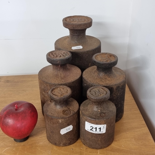 211 - A set of five heavy cast metal weights including 2kg, 5kg and 10kg.