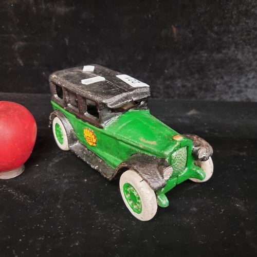 221 - A very charming heavy cast metal car - hand painted in emerald green and black, with articulated whe... 