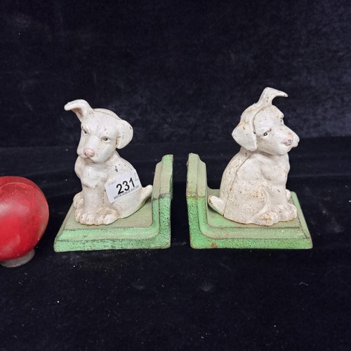 231 - A delightful pair of heavy cast metal book ends surmounted with adorable inquisitive puppies.