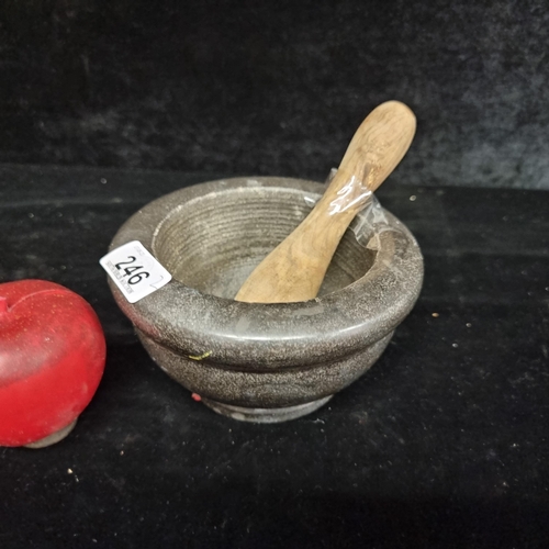 246 - A pestle and mortar with a heavy stone charcoal grey mortar and wooden pestle.