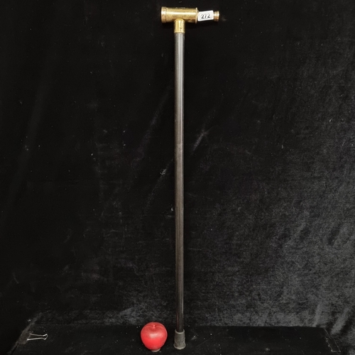 272 - An unusual walking cane with an integrated spyglass handle in a brass tone.