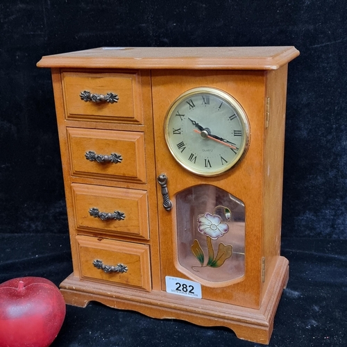 282 - A charming vintage jewellery box featuring four drawers, a necklace hanging compartment and a clock ... 