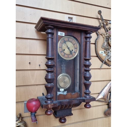 323 - Star Lot - An elegant antique wall clock with brass toned pendulum and clock face with roman numeral... 