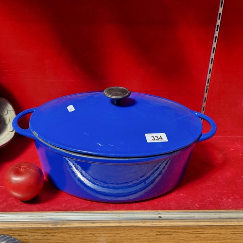 334 - A large enamelled cast iron Dutch oven with handles to sides and in a blue finish. A brilliant casse... 