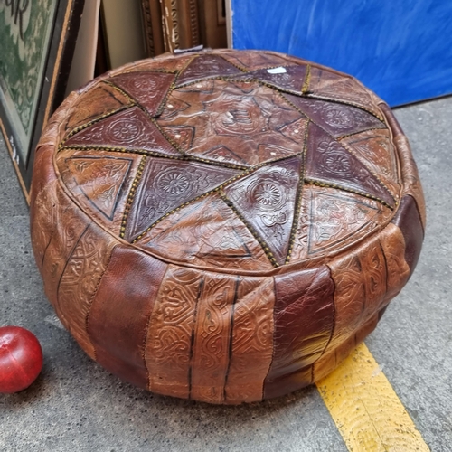 340 - - Star lot A vintage Moroccan leather foot stool boasting embossed detailing including a camel to ce... 