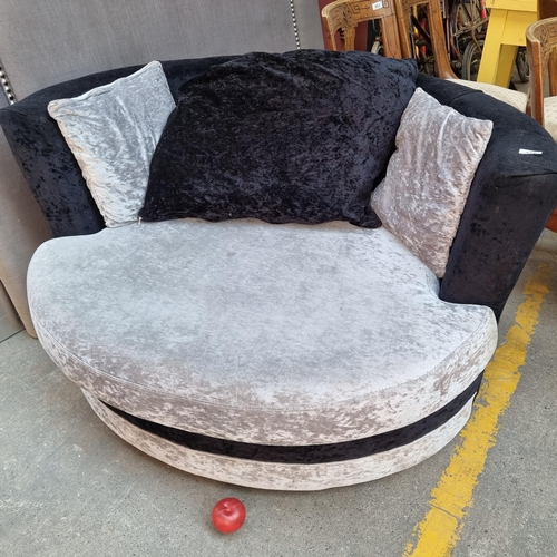 376 - A comfortable rotating loveseat upholstered in a grey and black plush fabric and with three matching... 