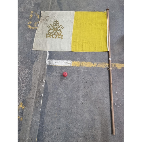 380 - A large vintage flag of Vatican City held on a long wooden staff. Flag MM: H90cm x W130cm. Staff MM:... 