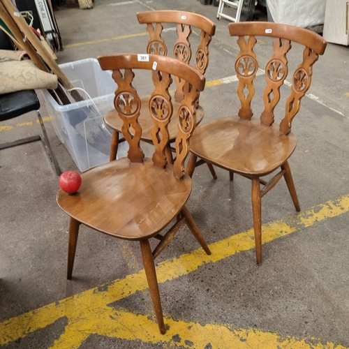 381 - A fabulous set of three Mid Century Ercol Fleur de Lys model no. 375 dining chairs. Featuring a char... 