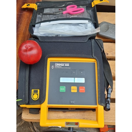 393 - A Medtronic Physio-Control LIFEPAK Defibrillator. With accompanying first aid accessories and origin... 