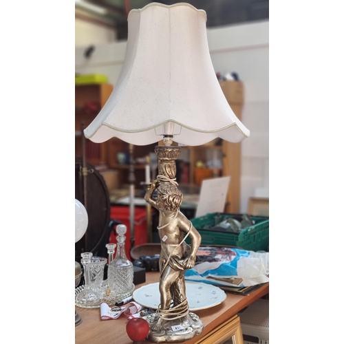 414 - A very large, very extravagant table lamp with figural stem in the form of a neo-classical young boy... 