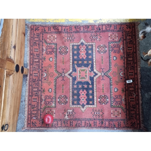 460 - Star lot : A neatly proportioned handmade, hand knotted woolen rug depicting Aztec motifs in shades ... 