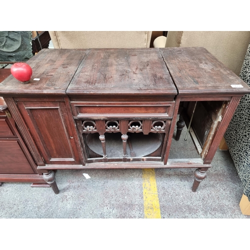 474 - An antique wind up phonograph sideboard by the Brunswicke, Balke - Collender Co. Featuring an integr... 