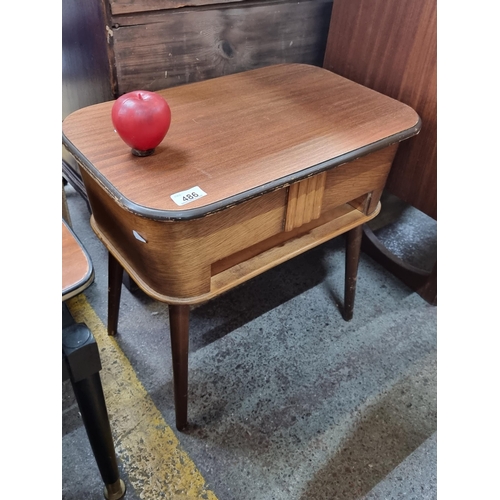 486 - Star lot : A handsome Mid Century Modern sewing table by Amorco with a teak top and pin feet. With a... 