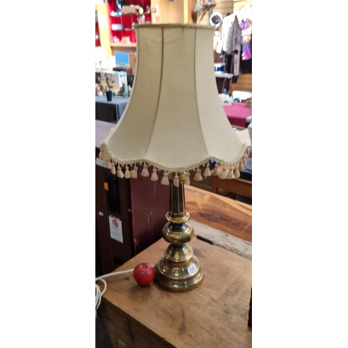 494 - A large table lamp with brass base. Featuring a faceted knop stem and reeded detail. Topped with a t... 