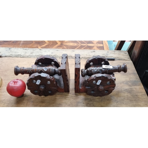 495 - A heavy pair of carved wooden bookends in the form of cannons. Crafted with particular attention pai... 