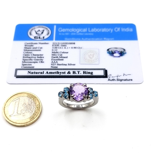 502 - An exquisite natural Amethyst and Blue Topaz ring, featuring a large fabulous central stone of 6.03 ... 