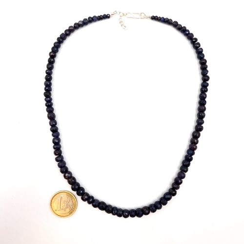 513 - Star Lot : A generous 220 carat facet cut Blue Sapphire necklace, featuring expertly matched cold to... 