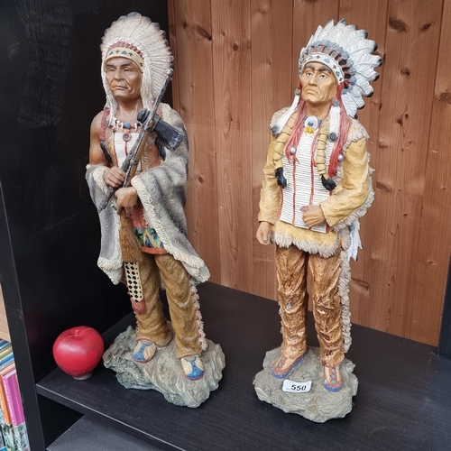 550 - Star Lot: Two tall statues of Native Americans chiefs donning large feathered head dresses. Height 5... 