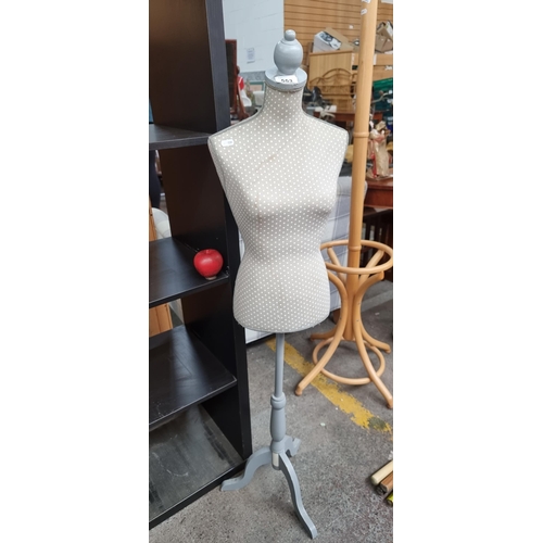 553 - A pretty girl's mannequin / dress form. This is upholstered in a cream and beige polka dot pattern. ... 