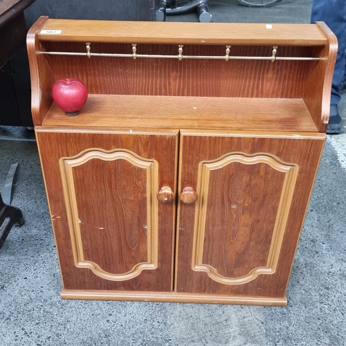 567 - A good sized wooden wall-mounting spice rack with two-door cupboard to top, revealing two shelves in... 