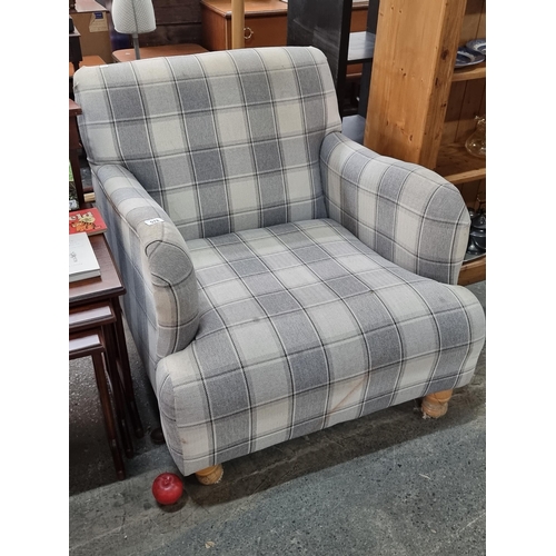 578 - A large deep armchair with turned wooden legs and upholstered in a cosy heavy plaid fabric A very co... 