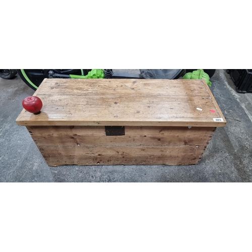 603 - An antique Pine storage chest with brass hinges.