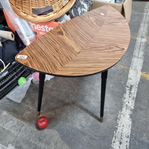 604 - A stylish mid century coffee table with leaf form top and held on three tapered legs each with brass... 