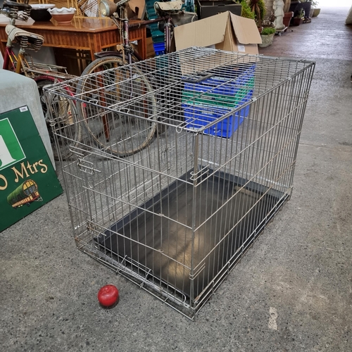 699 - A large dog cage with plastic tray to base. H72cm x L90cm x W62cm