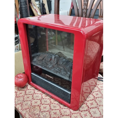 623 - A Dimplex branded electrical heater with an artificial fireplace front. Housed in a stylish red case... 