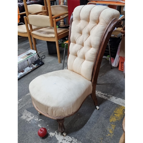 632 - An antique Victorian mahogany nursing chair. Featuring an elegant high back rest with carved detaili... 