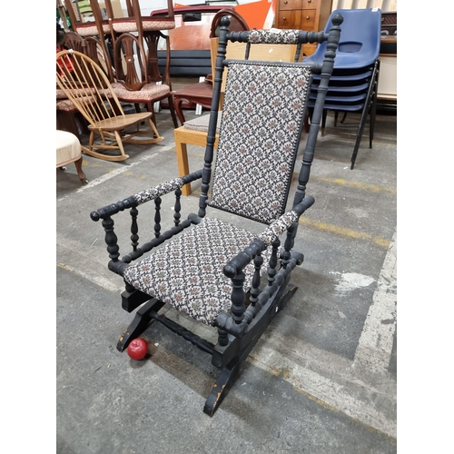 635 - A late Victorian style spring rocker. This elegant rocking chair features a profusely turned frame a... 