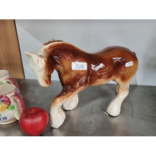 739 - A vintage ceramic figure depicting a Clydesdale horse in a two-toned finish. In VGC.