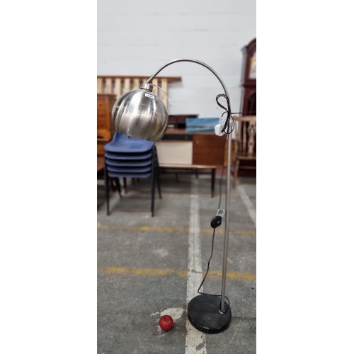 644 - A stylish contemporary floor lamp in a brushed chrome with a weighted base. A nice neat sized exampl... 