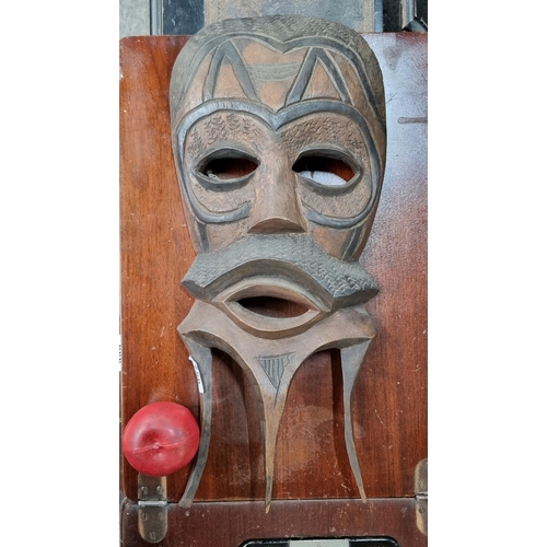 758 - A large hand carved solid wood African tribal mask with hook to back.