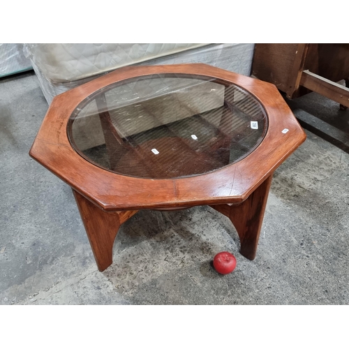 662 - A Mid-Century style coffee table after GPlan featuring an octagonal top and second tier to base with... 