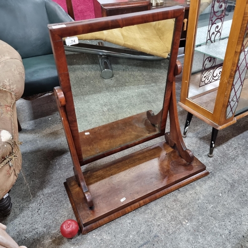 774 - A beautiful antique vanity mirror held in an adjustable wooden frame with scroll ornament supports.