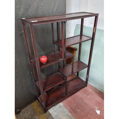 678 - A striking Chinese cherrywood shelving unit with four alternating shelves  with a dark stain. SD for... 