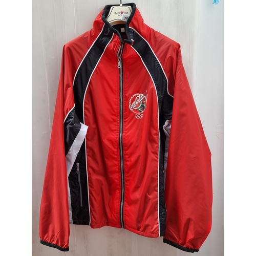 790 - A striking red and black windcheater men's jacket. With the Olympics logo and sponsor advertisement ... 