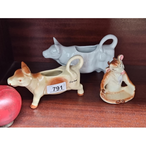 791 - Three ceramic cow figures including a two creamers and another in a yoga pose.