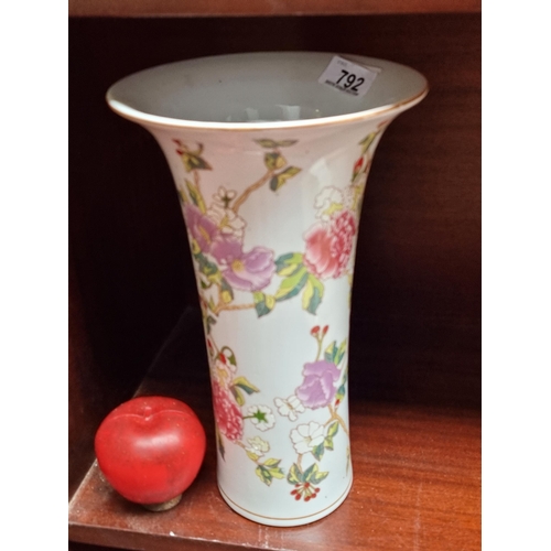 792 - A tall ceramic trumpet vase with a flared rim and a cherry blossom motif in shades of pink, purple a... 