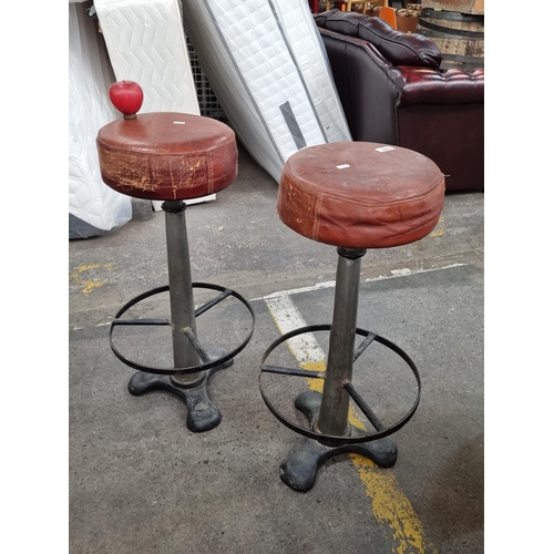 800 - Two very comfortable vintage bar stools with heavy cast metal bases, circular foots rest and upholst... 