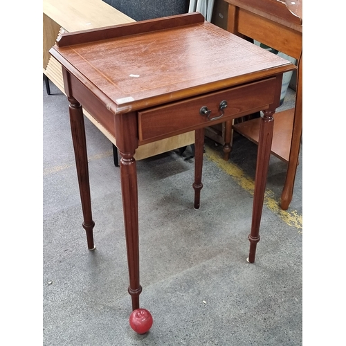 807 - A charming hall table with gallery back, string inlay to top and held on long fluted legs. With sing... 