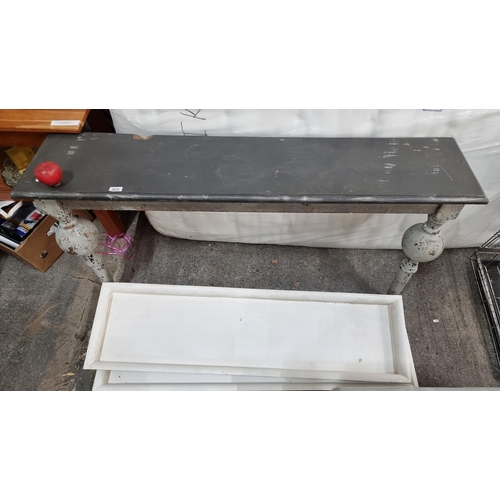 825 - A charming console table with two trough shelves, all in a grey shabby chic finish. The table has tw... 