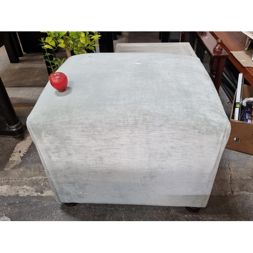 827 - A very large cube footstool upholstered in a soft grey fabric held on bun feet. Mm: L65 x W80 x H56c... 