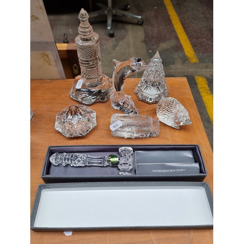 451 - Star Lot : A collection of 7 Waterford Crystal items including ornaments in the form of a lighthouse... 