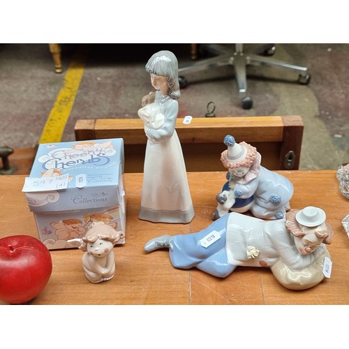 597 - Four spanish porcelain figurines including a Lladro clown figure, a Cheeky Cherub figure by Nao in o... 