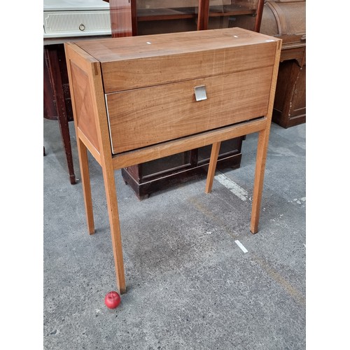 696 - An unusual tall wooden cabinet which folds out to reveal a working desk space with two internal stor... 