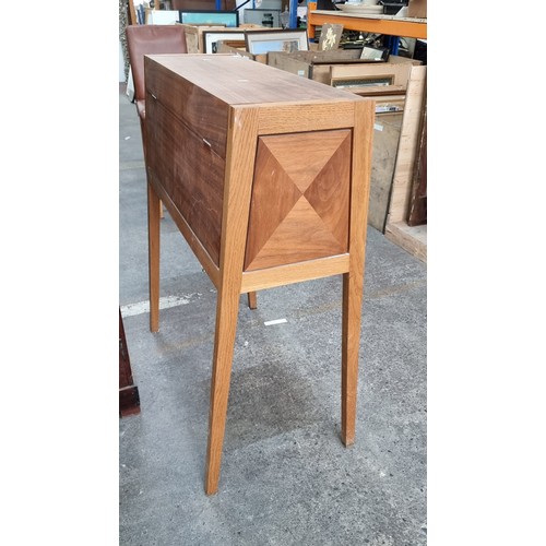 696 - An unusual tall wooden cabinet which folds out to reveal a working desk space with two internal stor... 