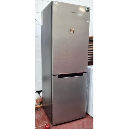 698 - Star Lot : A Samsung branded refrigerator / freezer. Model RB29FSRNDSA. A stylish silver grey unit w... 